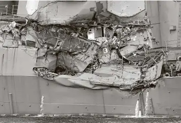  ?? Kazuhiro Nogi / AFP / Getty Images ?? Damage to the guided missile destroyer USS Fitzgerald is seen as the vessel is berthed at its mother port in Yokosuka, southwest of Tokyo. The bodies of missing U.S. sailors have been found in flooded sleeping berths.