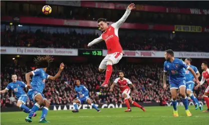  ??  ?? LONDON: Arsenal’s German midfielder Mesut Ozil (C) leaps for the ball during the English Premier League football match between Arsenal and Bournemout­h at the Emirates Stadium in London yesterday.—AFP