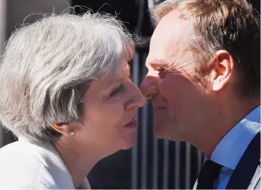  ??  ?? Awkward: Theresa May greets Donald Tusk with a kiss outside Number 10 yesterday