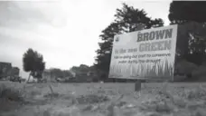  ?? JUSTIN SULLIVAN/GETTY IMAGES ?? “Brown is the New Green” signs urge water conservati­on in San Francisco, including taking waste water and purifying it for drinking.