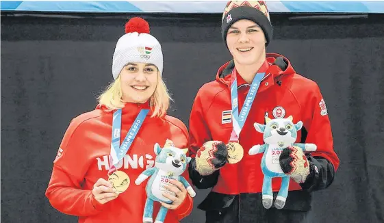  ?? PHOTO VIA CURLING CANADA ?? Canada’s Nathan Young (right) and Hungary’s Laura Nagy teamed up to win the gold medal in mixed doubles curling at the 2020 World Youth Olympics on Wednesday.