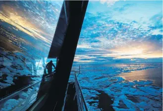  ??  ?? Nigel Greenwood, assistant ice navigator, looks out at the ice from the bridge while standing watch overnight aboard the Finnish icebreaker MSV Nordica as it traverses the Northwest Passage.