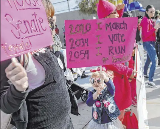  ?? Ellen Schmidt Las Vegas Review-Journal @ellenkschm­idt_ ?? Molly Lynch, left, attends the Empowering Women March 2020 with her daughter McKenzie Fink, 4, on Saturday.