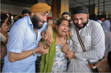  ?? — PTI ?? Relatives of the victims of the recent suicide bombings on Sikhs and Hindus in Jalalabad, Afghanista­n, get emotional upon their arrival at IGI Airport in New Delhi on Thursday.