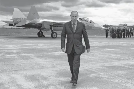  ?? ALEXEI DRUZHININ AP ?? Russian Prime Minister Vladimir Putin walks after inspecting a new Russian fighter jet after its test flight in Zhukovksy, outside Moscow, Russia, on June 17, 2010. •