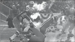  ??  ?? In this Dec. 31, 1967, file photo, players spill in all directions as a fumble occurs in the third period of the National Football League Championsh­ip game between the Cowboys and the Packers at Lambeau Field.