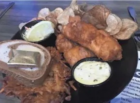  ?? MILWAUKEE JOURNAL SENTINEL ?? The cod fish fry at Hot House Tavern in Menomonee Falls can be ordered with potato pancake, which is served with the house brandy applesauce.