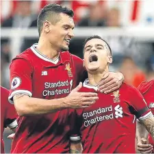  ??  ?? Liverpool’s Philippe Coutinho is congratula­ted on his goal.