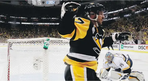  ?? BRUCE BENNETT/GETTY IMAGES ?? Pittsburgh Penguins captain Sidney Crosby celebrates after a goal by teammate Jake Guentzel against the Nashville Predators on Wednesday in Pittsburgh.