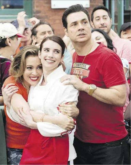  ??  ?? Emma Roberts, centre, seen with Alyssa Milano and Adam Ferrara in Little Italy, may star in a film about Italian cuisine, but she says she’s not much of a cook when she’s at home in her own kitchen.