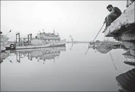  ?? Haidar Mohammed Ali AFP/Getty Images ?? ALONG the Shatt al Arab river estuary, where the Tigris and Euphrates meet, the water has grown brackish. Many Basrawis are unemployed, with little to do.