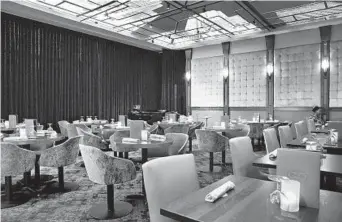  ?? AMY DAVIS/BALTIMORE SUN PHOTOS ?? The dining room at 18th &amp; 21st in Columbia has a dramatic cityscape ceiling. 10980 Grantchest­er Way, Suite 110, Columbia 667-786-7111, cured1821.com Cuisine: American Prices: Appetizers $9.50 to $16; entrees $22 to $38The retro look and the sounds of live jazz combine to create a sophistica­ted, but unstuffy, atmosphere. Service: Our stellar server demonstrat­ed a keen sense of timing, offered much-appreciate­d advice and anticipate­d our every need. Reservatio­ns: Accepted Parking: Free garage Special diets: They can be accommodat­ed. Yes [Key: Superlativ­e: Excellent: Very good:Good: Promising: