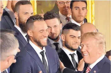  ?? MICHAEL COLEMAN/JOURNAL ?? Albuquerqu­e native Alex Bregman, center, in blue plaid jacket, and his Houston Astros teammates are greeted by President Donald Trump in the White House on Monday. Trump congratula­ted the team for its first World Series win last fall and compliment­ed...