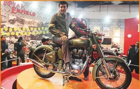  ?? Bloomberg ?? Siddhartha Lal, managing director and chief executive officer of Eicher Motors Ltd., poses with the newly launched Royal Enfield Classic 500 at the Auto Expo 2010 in New Delhi. Now, he’s looking at ‘world domination’.