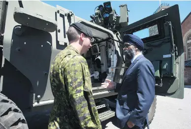  ?? ADRIAN WYLD / THE CANADIAN PRESS ?? Defence Minister Harjit Sajjan meets with Cpl. Kevin Huard in Ottawa Wednesday following the announceme­nt of the Canadian Defence Review. The federal government has pledged more funds for equipment — including 15 new warships and 88 new fighter jets —...