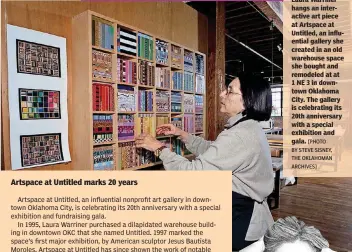  ?? [PHOTO BY STEVE SISNEY, THE OKLAHOMAN ARCHIVES] ?? In this 2002 photo, Laura Warriner hangs an interactiv­e art piece at Artspace at Untitled, an influentia­l gallery she created in an old warehouse space she bought and remodeled at at 1 NE 3 in downtown Oklahoma City. The gallery is celebratin­g its 20th...