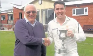  ?? Louis Burns ?? Widnes Cricket Club first XI skipper Chris Kirby is presented with the Vivio Cheshire County Cricket League Second Division trophy by league chairman David Humpage.