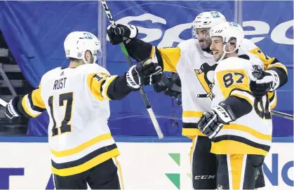  ?? PITTSBURGH PENGUINS • SPECIAL TO THE GUARDIAN ?? Pittsburgh Penguins defenceman Pierre-Olivier (P.O.) Joseph, centre, celebrates with Sidney Crosby, right, and Brian Rust after Joseph set up Crosby for Saturday's overtime winner against the New York Rangers.