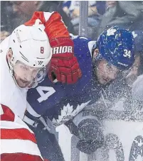  ?? STEVE RUSSELL TORONTO STAR ?? Detroit’s Justin Abdelkader rides the Leafs’ Auston Matthews into the boards in Thursday night’s game at Scotiabank Arena.