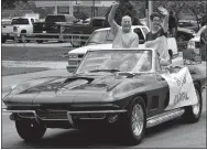  ?? Westside Eagle Observer/MIKE ECKELS ?? Bill Montgomery (left) and wife Michal wave as they lead the Decatur Barbecue parade through downtown Decatur last year. The parade will return to downtown Decatur on Aug. 4 during the 65th Annual Decatur Barbecue. The theme for this year’s event is...