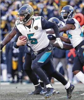  ?? ROB CARR / GETTY IMAGES ?? Quarterbac­k Blake Bortles runs with the ball as the Jaguars defeated the Steelers in the AFC divisional round Sunday at Heinz Field in Pittsburgh.