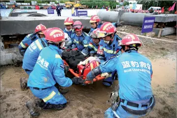  ?? — Reuters photo ?? Members of a rescue team take part in a rescue skills competitio­n ahead of the 10th anniversar­y of the 2008 Sichuan earthquake, in Mianyang.