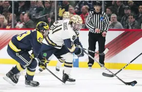  ?? — THE ASSOCIATED PRESS FILES ?? Jeff Tambellini spent the 2017-18 season coaching Quinn Hughes, left, as a University of Michigan assistant.