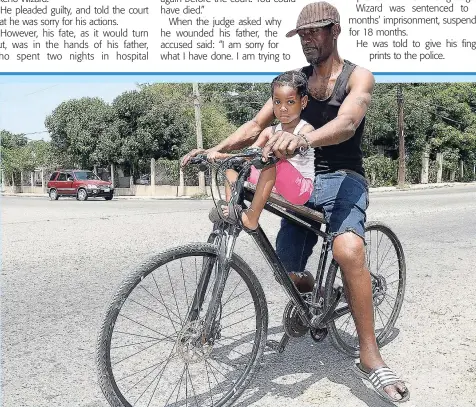  ?? LIONEL ROOKWOOD ?? Two-year-old Abrianna Smith was seen going for a ride with her dad, Christophe­r Smith, along Slipe Road, Kingston, earlier this week.