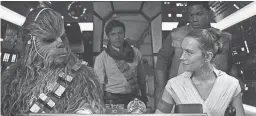  ??  ?? Chewbacca (Joonas Suotamo), Poe (Oscar Isaac), Finn (John Boyega) aboard the Millennium Falcon in “Star Wars: The Rise of Skywalker.”