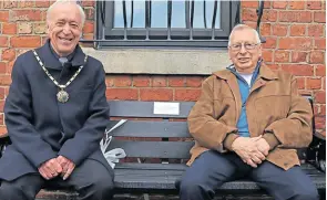  ?? ?? Burscough Town Council chairman Coun Brian Kennedy and the BHG chairman Tom Spencer take the first sit on one of two new canalside benches.