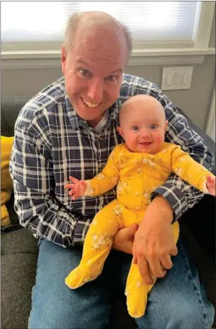  ?? COURTESY JIM HOHMAN ?? Longtime Twin Cities resident Jim Hohman ran the Boston Marathon twice in the 1980s, the second time after being diagnosed with cancer. He’s pictured here with granddaugh­ter Sophia, the light of his