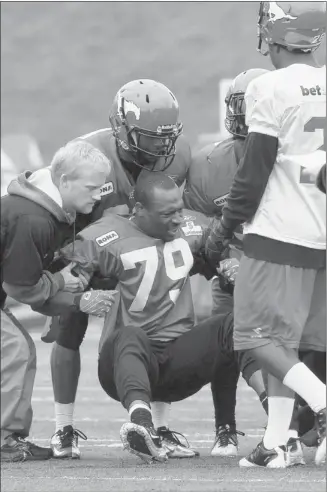  ?? Photos, Christina Ryan, Calgary Herald ?? Calgary Stampeders Maurice Price was injured during training camp at McMahon Stadium on Saturday.