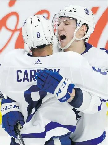  ?? ADRIAN WYLD/THE CANADIAN PRESS ?? Toronto Maple Leafs defenceman Connor Carrick, left, is congratula­ted by teammate Travis Dermott after scoring the go-ahead goal against the Ottawa Senators in the third period on Saturday in Ottawa. The Leafs, who are missing two regular defencemen,...