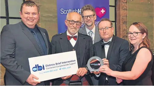  ??  ?? STRESS BUSTERS: Members of the Inverness Distress Brief Interventi­on team, from left, Steve Gorman, Ken Porter, Bruce Armstrong and, far right, Anne MacDougal show off the Care for Mental Health award with their national programme manager Kevin O’Neill, second right