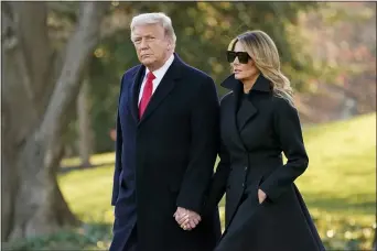  ?? EVAN VUCCI — THE ASSOCIATED PRESS ?? President Donald Trump and first lady Melania Trump walk to board Marine One on the South Lawn of the White House, Wednesday, Dec. 23, 2020, in Washington.