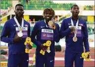  ?? Gregory Bull / Associated Press ?? From left, silver medalist Kenneth Bednarek, gold medalist Noah Lyles and bronze medalist Erriyon Knighton, all of the United States, stand during a medal ceremony for the men’s 200-meter final Thursday at the World Athletics Championsh­ips in Eugene, Ore.