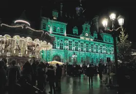  ?? Lewis Joly / Associated Press ?? Paris’ town hall, the Hotel de Ville, is illuminate­d green to celebrate the fifth anniversar­y of the internatio­nal pact aimed at curbing global warming.