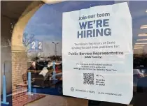  ?? Nam Y. Huh/Associated Press ?? A hiring sign is displayed at the Department of Motor Vehicles office in Deerfield, Ill., Dec. 12. On Thursday, the Labor Department reported on the number of people who applied for unemployme­nt benefits last week.