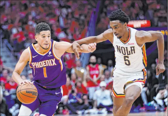  ?? Gerald Herbert The Associated Press ?? The top-seeded Phoenix Suns got by the New Orleans Pelicans in the first round despite losing All-star guard Devin Booker (1) for three games with a hamstring injury.