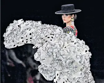  ?? ?? Flamenco flourish A model brings some Andalusian style to the catwalk in a creation by Con T D’touché at Simof 2023, the internatio­nal flamenco fashion show in Seville, Spain.