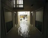  ?? GREGORY BULL — THE ASSOCIATED PRESS ?? In this Aug. 29 file photo, Steven Hathaway searches for people to help in an apartment complex in Kingwood, Texas. Authoritie­s say standing water will contain untreated sewage, along with spilled fuel and toxic waste. They’re urging residents to stay...