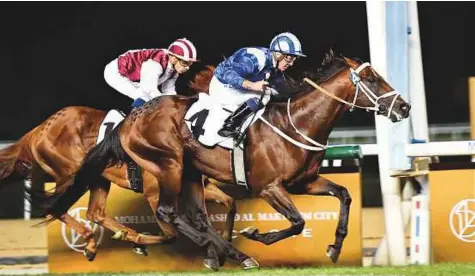  ?? Virendra Saklani/Gulf News ?? Janoobi, ridden by Jim Crowley (in blue and white) and trained by Mike De Kock on way to winning the Zabeel Mile at Meydan during the Dubai World Cup Carnival.