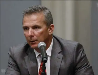  ?? PAUL VERNON — THE ASSOCIATED PRESS ?? Ohio State coach Urban Meyer makes a statement during a news conference in Columbus, Ohio on Wednesday night. Ohio State suspended Meyer for three games for mishandlin­g domestic violence accusation­s, punishing one of the sport’s most prominent leaders for keeping an assistant on staff for several years after the coach’s wife accused him of abuse.