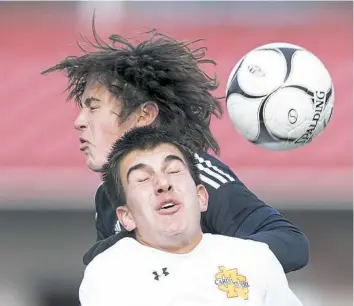  ??  ?? Cardinal Wuerl North Catholic’s Nick Milas heads the ball against Mercer’s Jackson Hazelet in a PIAA Class A quarterfin­al match Saturday. North Catholic advanced with a 1-0 win.