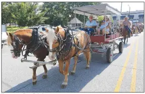  ?? (NWA Democrat-Gazette/David Gottschalk) ?? Wagon master Kenny Underdown and his wife, Pam, lead the Harrison Roundup Club’s wagon train Friday through downtown Harrison. The wagon train left the Northwest Arkansas District Fairground­s in Harrison and traveled through downtown before heading out on a five-day trip to Blue Springs, located just east of Springdale. Visit nwaonline.com/200620Dail­y/ and nwadg.com/photos for a photo gallery.