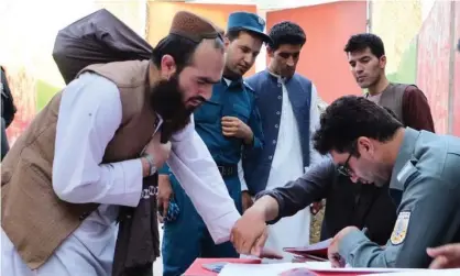  ??  ?? Afghan security forces register the release of Taliban prisoners in Kabul. Photograph: Xinhua/REX/Shuttersto­ck
