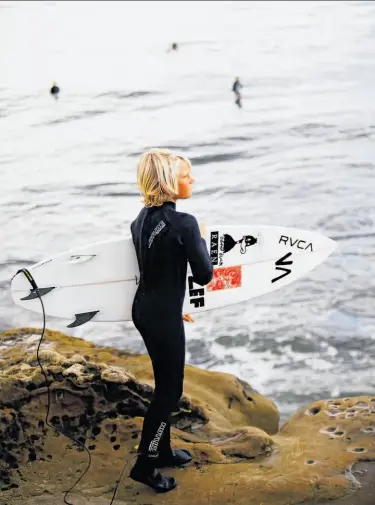  ?? Photos by Craig Lee / Special to The Chronicle ?? A young surfer scans the break off Santa Cruz. The Pleasure Point neighborho­od is home to an assortment of cafes serving the sort of hearty fare that’s especially welcome after a morning in the water.