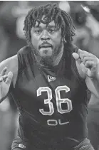  ?? AP ?? Memphis offensive lineman Dylan Parham runs a drill during the NFL football scouting combine on March 4 in Indianapol­is.