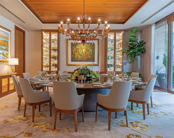  ??  ?? This page:
The gorgeous round table in a Walnut Canaletto finish with a crystal lazy susan is by Giorgetti. Flanked by Eduardo’s prized collection of Flora Danica porcelain is the homeowner’s favourite art piece–a luminous Anita Magsaysay. Complement­ing this are a pair of Juvenal Sanso
Opposite, clockwise
from top: The main kitchen is by Poliform; The outdoor table is by Giorgetti with chairs from Kettal; A closer look at her exquisite Royal Copenhagen Flora Danica tableware