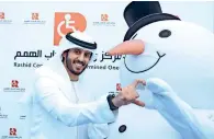 ??  ?? ALL SMILES HErE: Emirati entreprene­ur Abdulaziz Ahmed joins Baskin-robbin’s snowman to spread happiness at the rashid center for people of determinat­ion. — Photos by Juidin Bernarrd